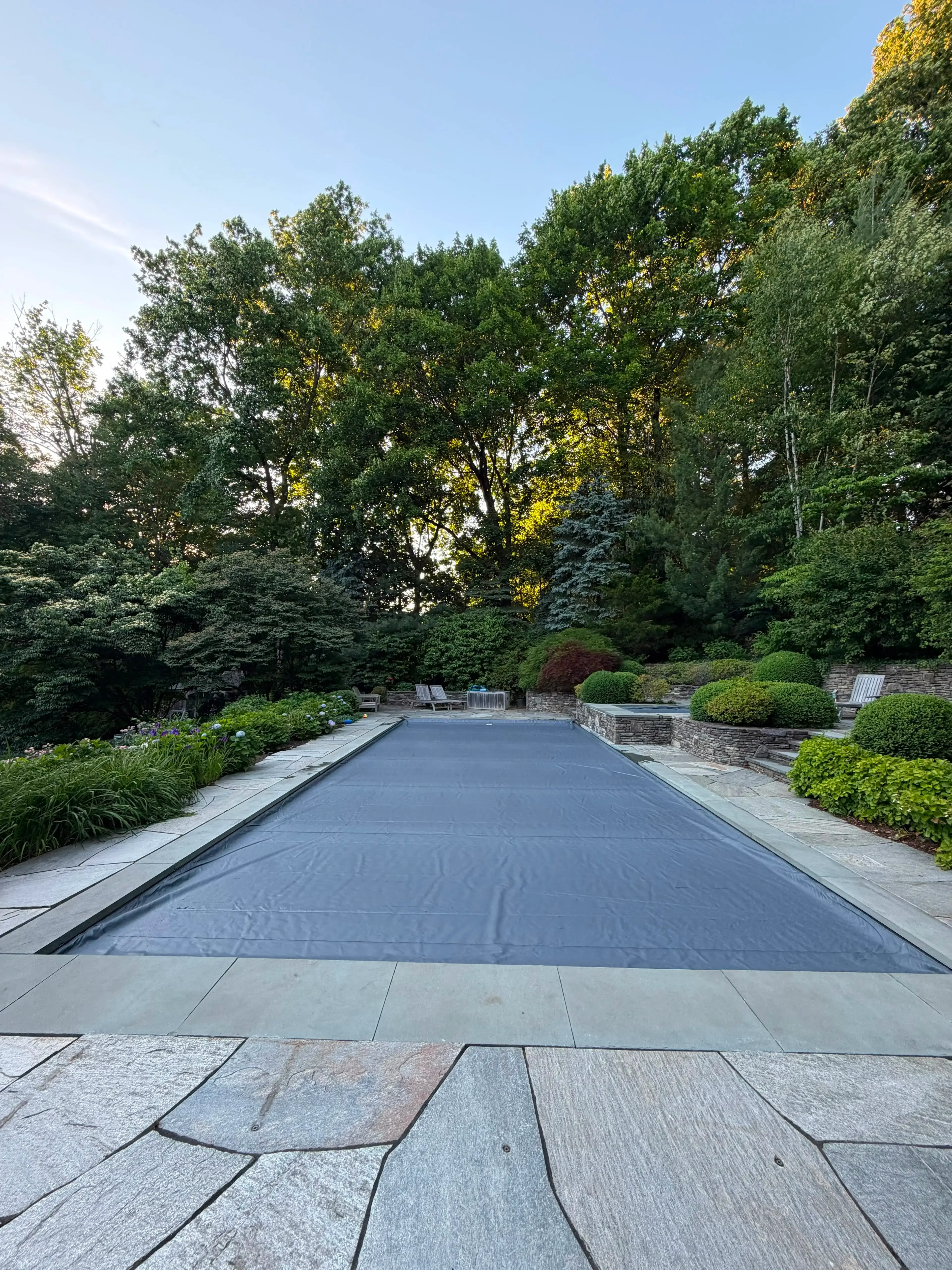 Custom fit automatic cover drawn across a rectangular in-ground pool