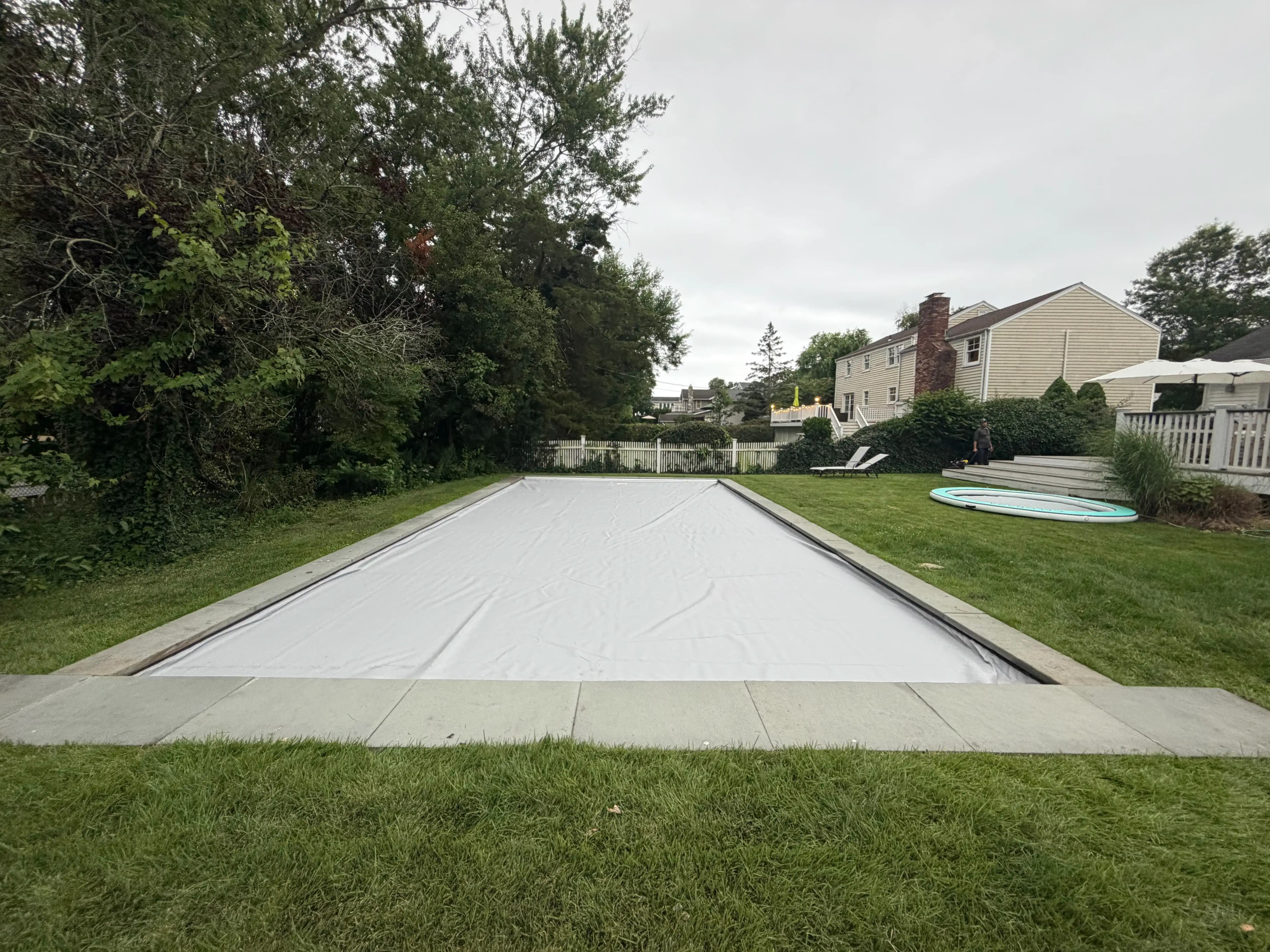 Automatic pool cover system on a coastal Rhode Island swimming pool