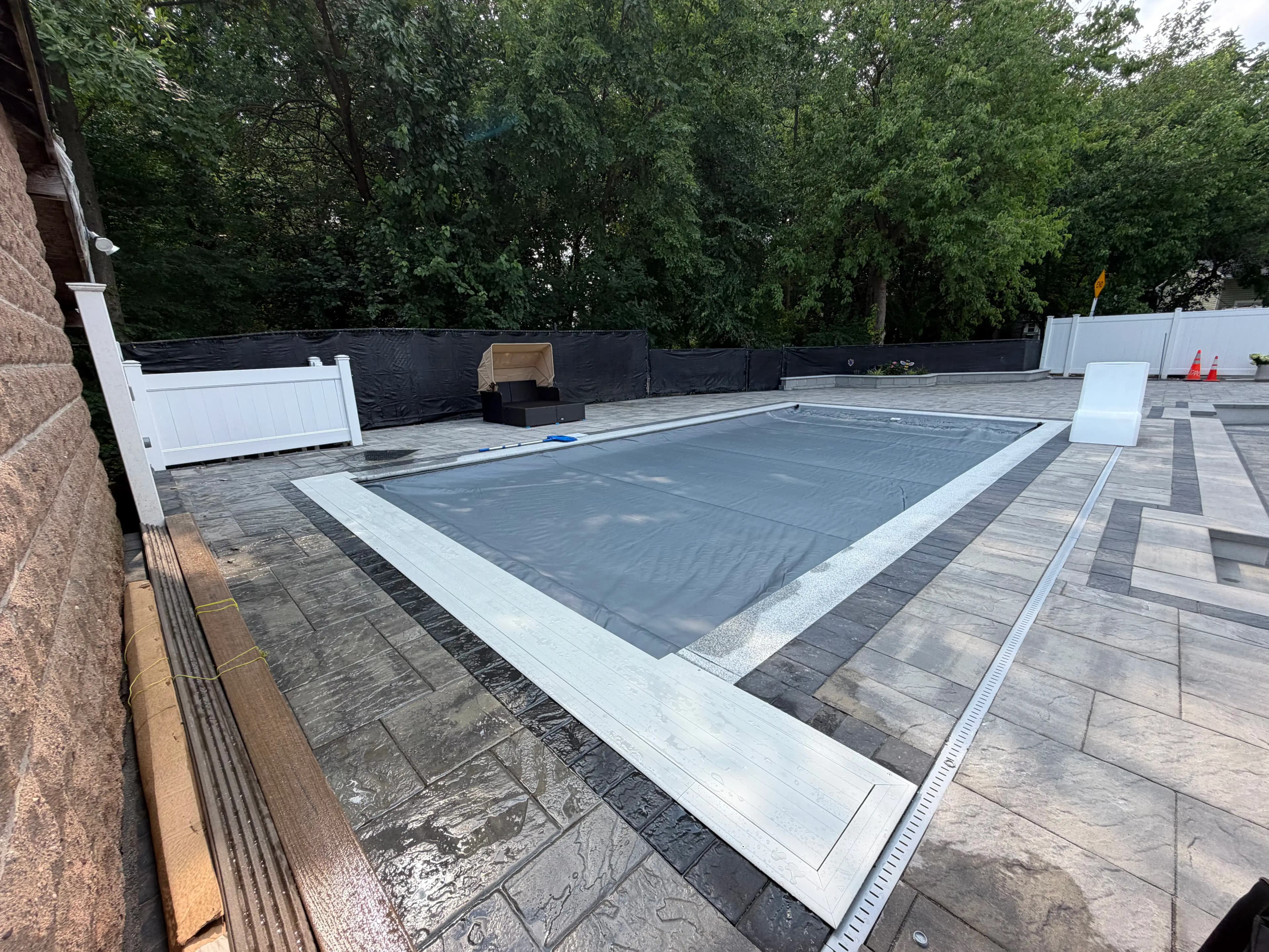 Automatic pool cover installed on an in-ground pool in central Massachusetts